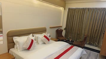 Deluxe Room, City View | In-room safe, desk, laptop workspace, blackout drapes