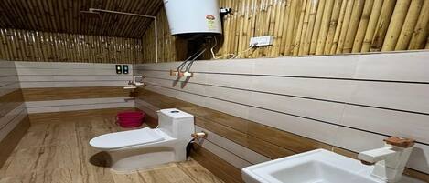 A bathroom with a wooden ceiling, a toilet, a sink, and a water heater.