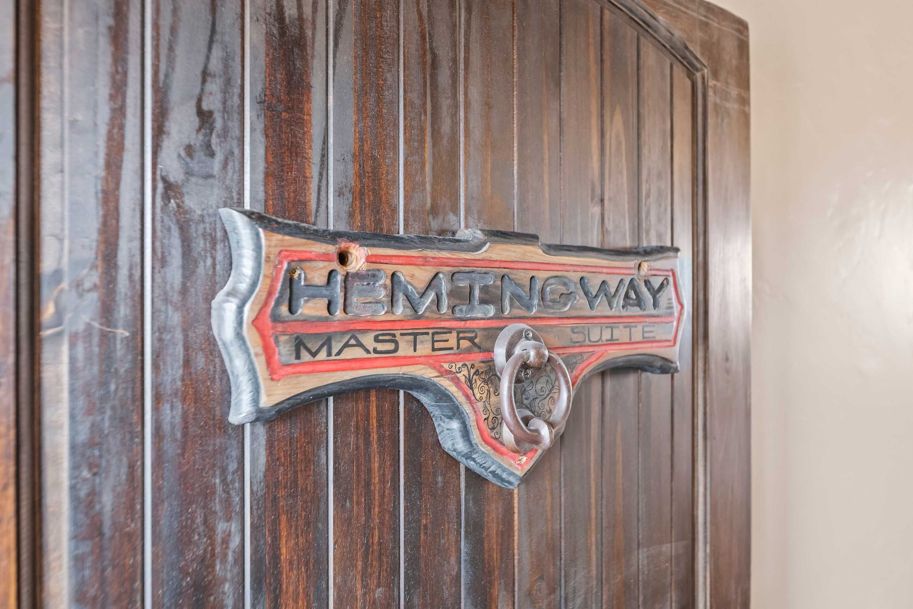 A wooden door with a decorative sign that reads "Hemingway Master Suite."