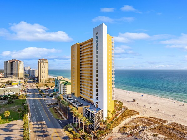 A high-rise hotel with a beach view, multiple floors, and a parking area. - New UNIT, Penthouse with gulf views close to pier park! (Panama City Beach)