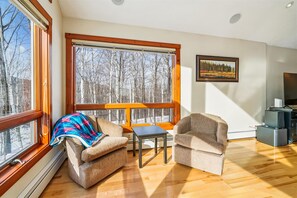 Sunny Sitting Area - Large windows and comfortable seating create a bright spot to relax and enjoy the wooded views. - 3 bedroom pet-friendly Killington retreat with fireplace and room for 8. (Killington)