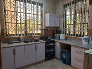 Private kitchen - Eddies  2 Bedroom Apartment with Fast Wifi close to Mall and Kokrobite Beach. (Greater Accra Region)