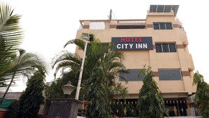 A hotel named "HOTEL CITY INN" with a modern facade, solar panels on the roof, and a gated entrance. - HOTEL CITY INN (Nagpur)
