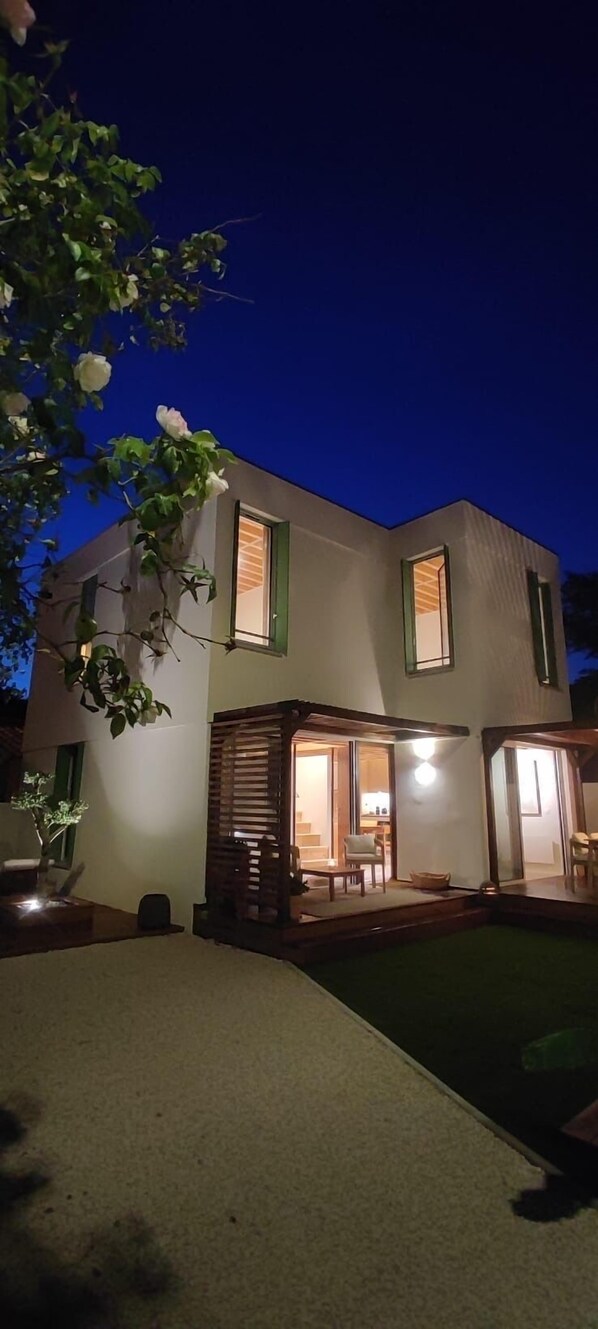 A modern two-story house with a well-lit patio area and a visible interior. - Exceptional property, 3 suites—50 m from the beach. Entire property: Villa Hyères, France (Hyères)