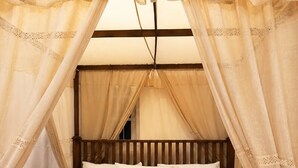 A bed with a canopy, wooden headboard, and white pillows. - Aura Hilltop Matale (Matale)