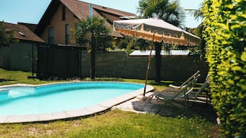 Seasonal outdoor pool, open 5:00 PM to 9:00 PM, pool umbrellas