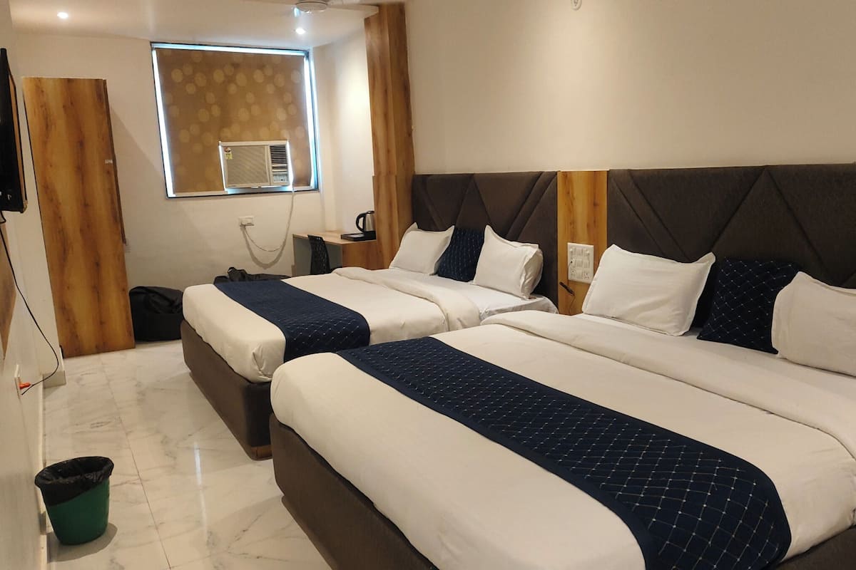 Family Quadruple Room, Garden View | In-room safe, desk, laptop workspace, blackout drapes