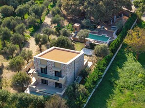 A modern house with a swimming pool, surrounded by trees and greenery. - Family Estate ,4 BR Villa + 2 BR Guesthouse ,  Privat Pool & Playground , Rhodes (Ialisos)