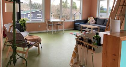 Colorful upstairs studio with lofted bed and soaking tub