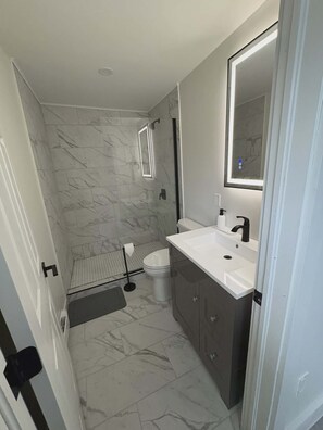 Shower, towels, soap, toilet paper - Historic Barn Conversion | Downtown Yarmouth | King Bed (Yarmouth)