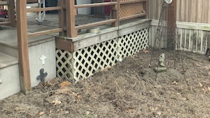 A covered porch with a wooden railing, a metal bench, and a small statue. - Cozy 2-bedroom cabin in fabulous Alba with cool AC . Only 8miles from lake fork (Alba)
