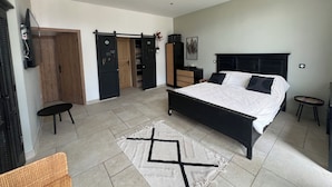 A bedroom with a large bed, a wardrobe, a chest of drawers, and a small table. - VILLA PROVENCALE (Salon-de-Provence)