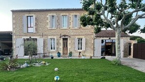 A stone house with a well-maintained lawn and a soccer ball in the foreground. - VILLA PROVENCALE (Salon-de-Provence)