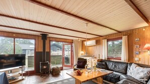 A cozy cabin interior with a fireplace, leather sofa, and a television. - "Samine" - 1.2km from the sea by Interhome (Blåvand)