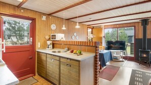A cozy kitchen with wooden cabinets, a sink, and a stove. - "Samine" - 1.2km from the sea by Interhome (Blåvand)
