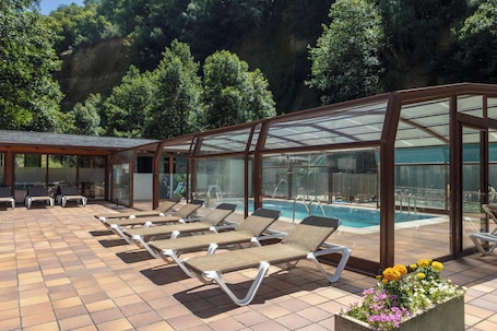 Una piscina techada, sillones reclinables de piscina. Hotel-Restaurante Tixileiro