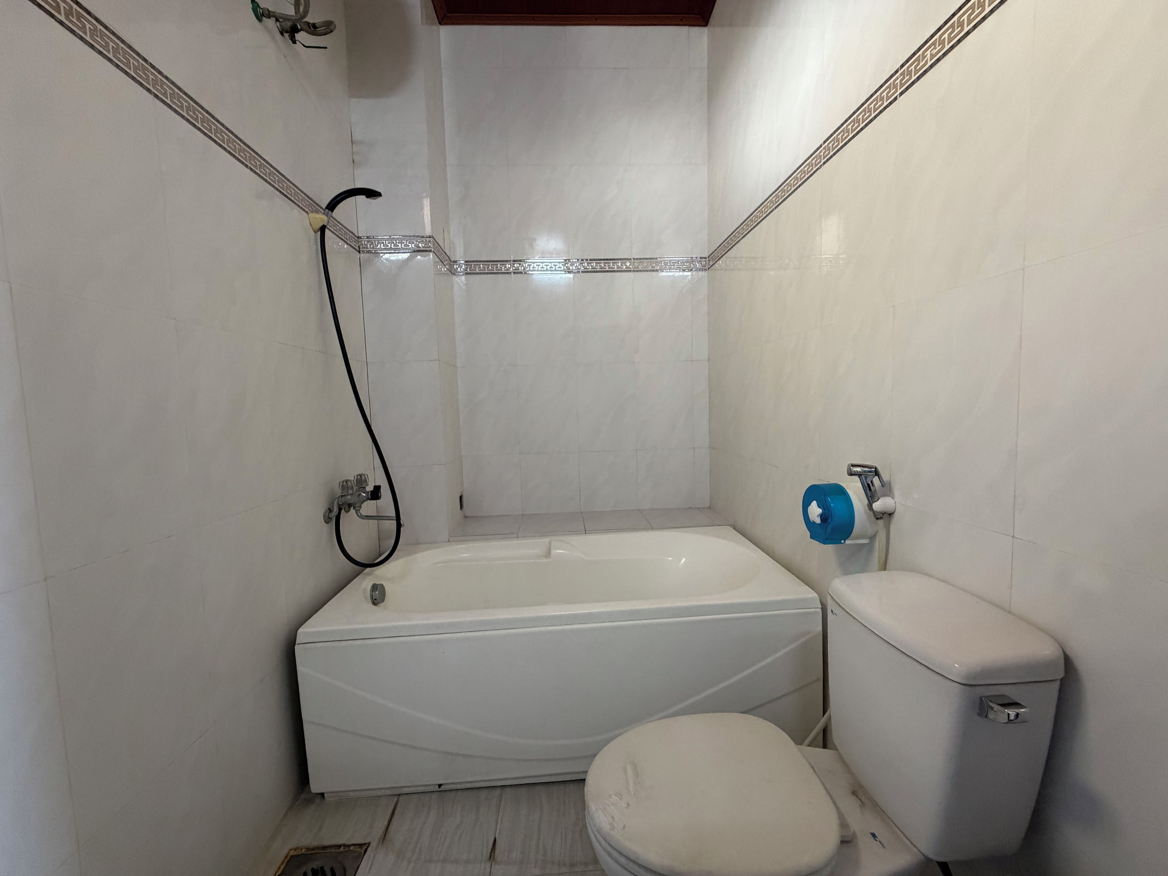 A bathroom with a bathtub, toilet, and shower.