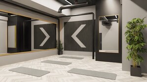 A modern room with a herringbone floor pattern, large mirrors, and a potted plant. - Student Only True Leicester (Leicester)