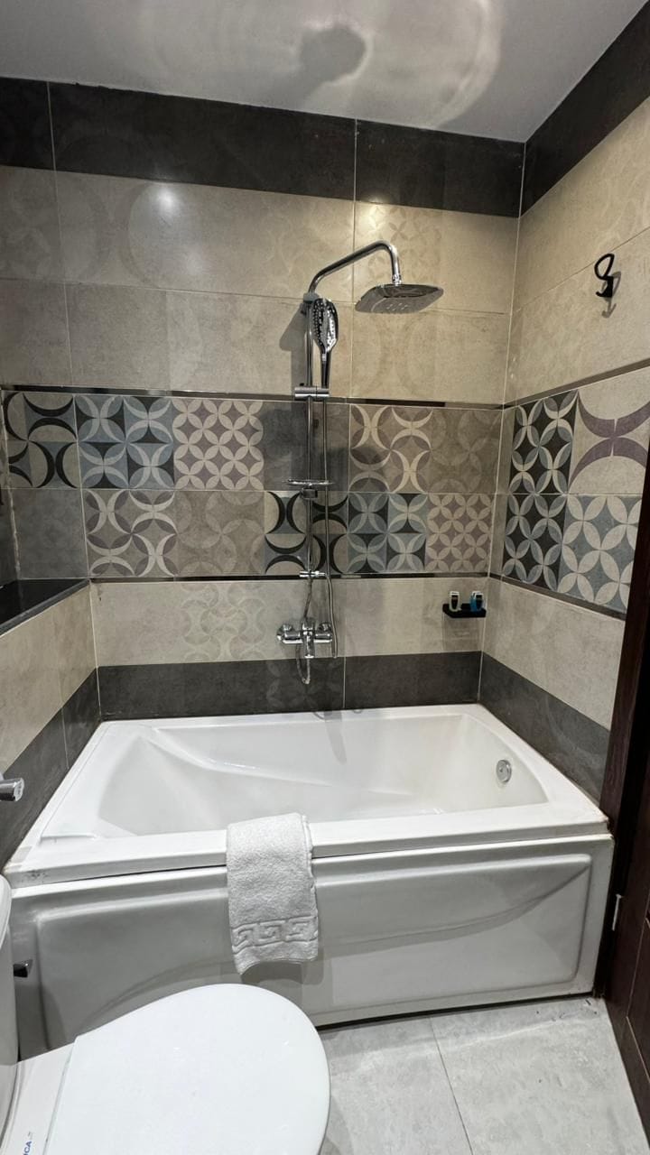 A bathroom with a bathtub, a shower, and a toilet.