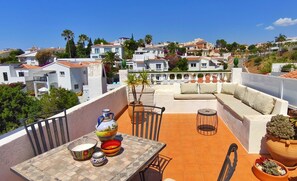 A rooftop terrace with a table, chairs, a sofa, and potted plants. - Sea view-Town-House-Comfort-Private Bathroom (Nerja)