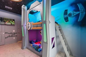A Star Wars-themed room with a bunk bed, a ladder, and a wall mural. - 3071 Mahalo Dr · Brand New Windsor Island 10br Mansion/pool/spa (Davenport)