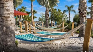 A beach scene with hammocks and palm trees. - 3739la · Brand New 10br/pool/spa/ Disney Fireworks View (Davenport)