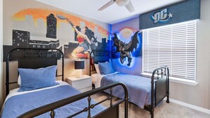 A bedroom with two beds, a cityscape mural, a ceiling fan, and a window with blinds. - Psd816 (Davenport)