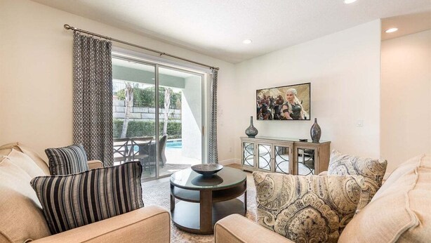 A living room with a sofa, a coffee table, and a cabinet. - 350-360 Huge Villas - Near Disney - 15 BDs (Kissimmee)