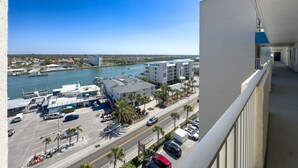 A balcony with a view of a marina, a river, and a cityscape. - 20002 Gulf Blvd, Penthouse 5 (Indian Shores)