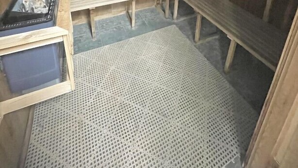 Ein Saunaraum mit Bänken und einem kleinen Tisch.