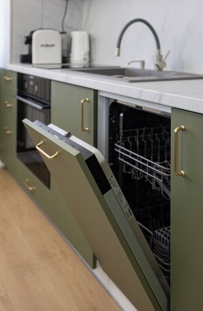 A kitchen with a dishwasher, a sink, and a toaster.
