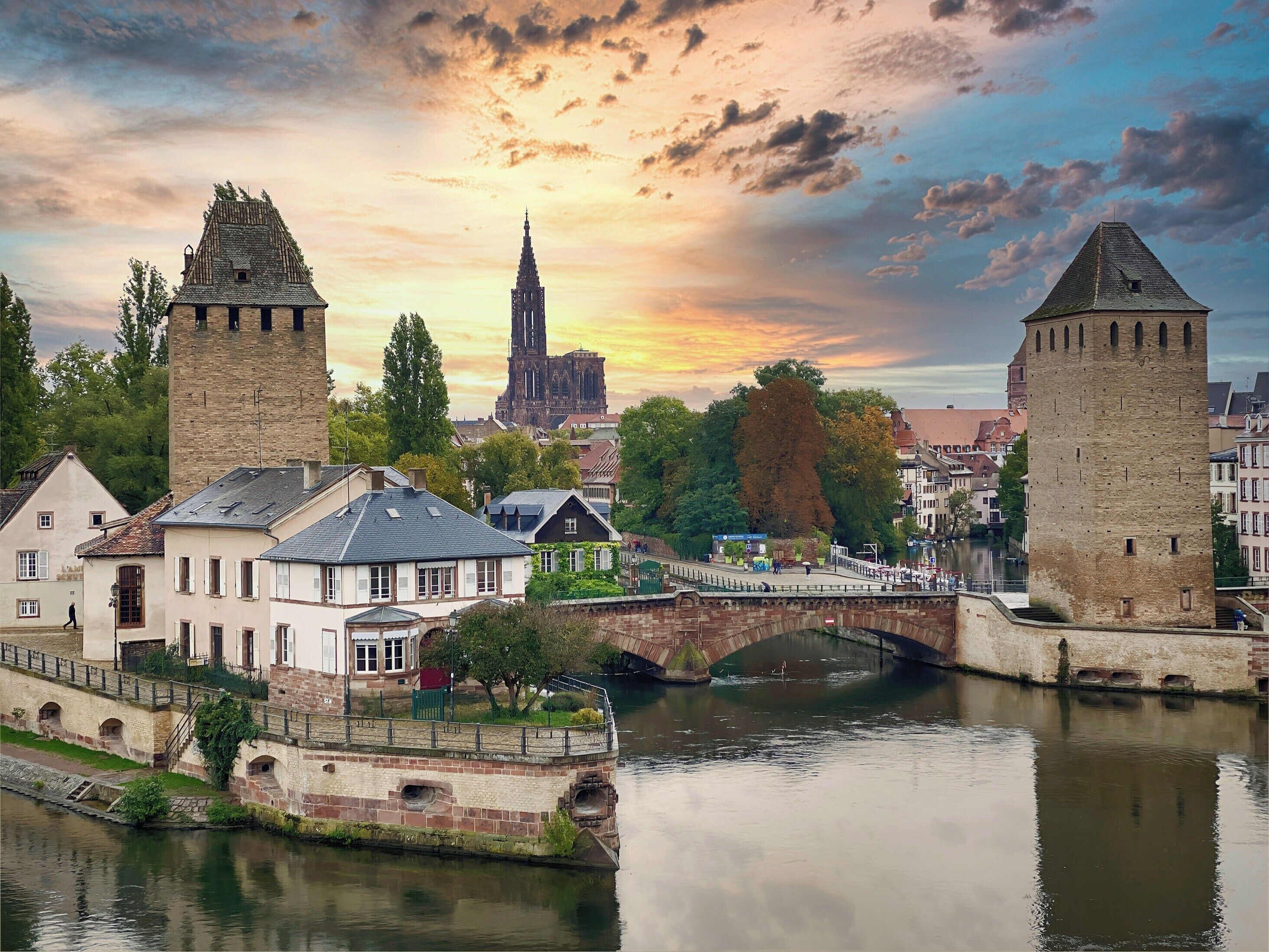 A historic town with a river, stone bridges, and traditional architecture.