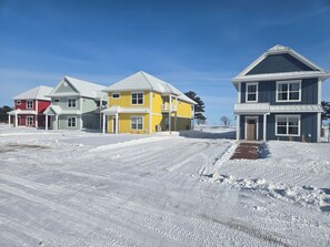 A residential area with houses, a clear sky, and snow-covered ground. - #3 Yellow Lakeview Suite A (Garrison)