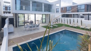 A modern two-story house with a swimming pool, outdoor seating, and a well-maintained garden. - Protaras Aqua Pearl Villa AQ05 by Interhome (Protaras)