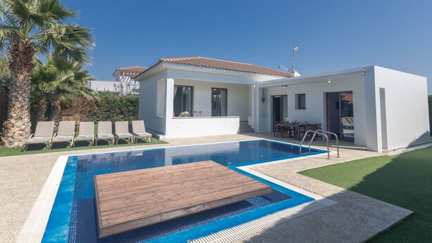 A modern house with a swimming pool, a patio, and a garden with palm trees. - Ayia Napa Satin Villa SVI1 by Interhome (Ayia Napa)