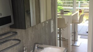 A modern bathroom with a large mirror, a white sink, and a towel rack. - Hausboot KHT 2 Lacet mit Elektrokamin im Salon, 1 Schlafraum, Küche, Duschbad m by Interhome (Wilhelmshaven)