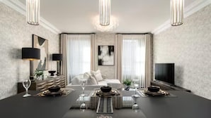 A modern dining area with a long table, elegant lighting, and a cozy seating arrangement. - Near Transport - Hot tub - Fireplace - Sleeps 2 (Edinburgh)