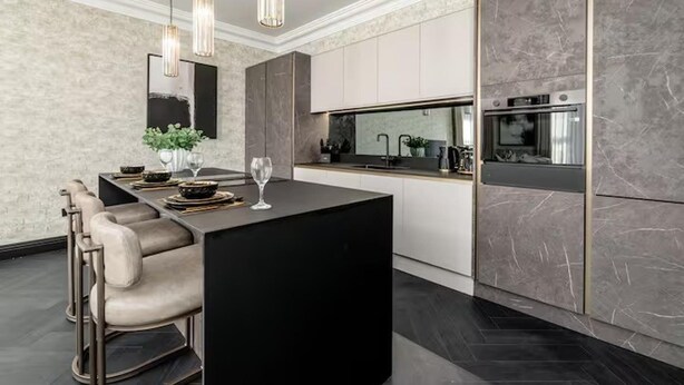A modern kitchen with a central island, bar stools, pendant lighting, and a built-in oven. - Near Transport - Hot tub - Fireplace - Sleeps 2 (Edinburgh)