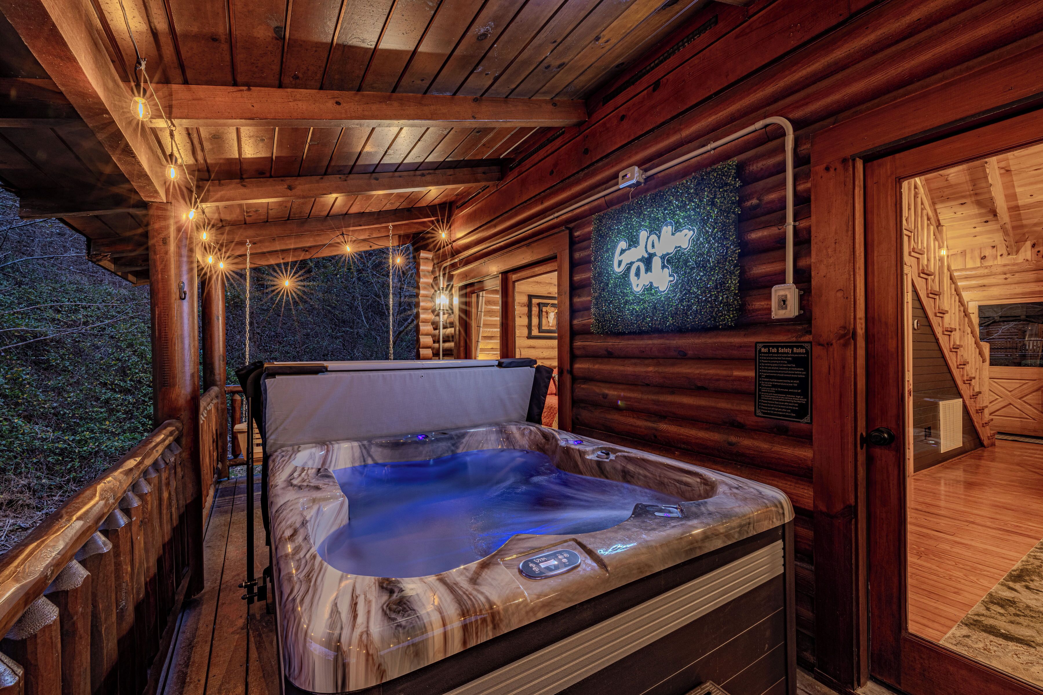 A wooden cabin interior with a hot tub, wooden beams, and a sign reading "Columbia Out."