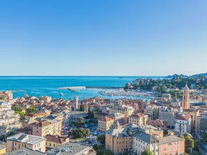 A coastal cityscape with historic buildings, a marina, and a prominent church tower. - Schöne Wohnung in Rapallo by Interhome (Rapallo)