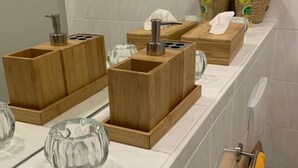 A modern bathroom with wooden sinks, a glass bowl, and a towel rack. - Design Apartment I by Interhome (Görlitz)