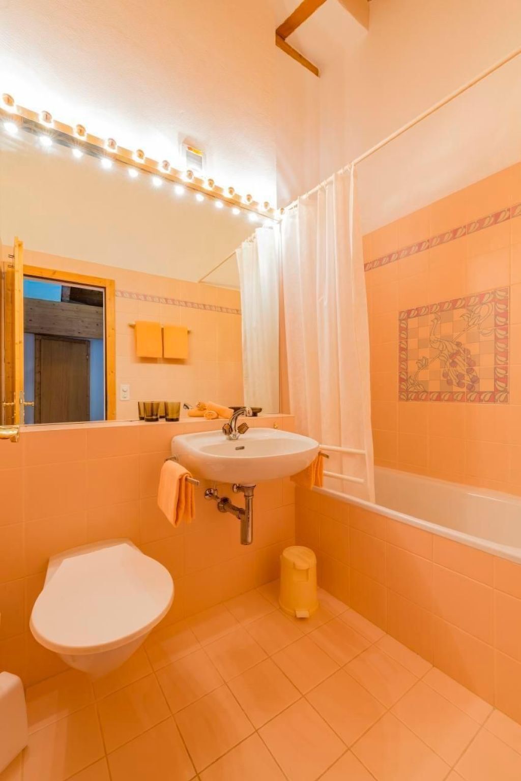 A bathroom with a sink, toilet, and bathtub.