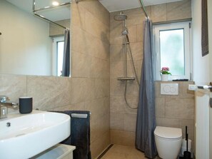 A modern bathroom with a shower, toilet, and sink. - Fewo Am Sommerberg by Interhome (Donaueschingen)