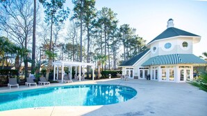 A pool area with lounge chairs and a gazebo, surrounded by tall trees. - World Tour 104-202a (Myrtle Beach)