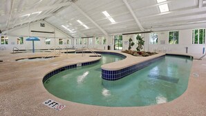 An indoor swimming pool with a 3 FT depth marker, surrounded by a tiled deck and a covered roof structure. - Magnolia North 4843-103 (Myrtle Beach)
