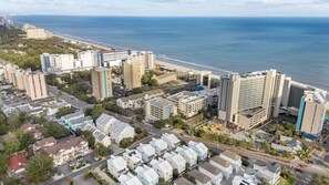 An aerial view of a coastal city with high-rise hotels, a beach, and residential areas. - Ocean Dunes 6054 (Myrtle Beach)