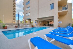 A swimming pool with blue lounge chairs and a lifeguard on duty sign. - Ocean Dunes 6054 (Myrtle Beach)