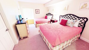 A bedroom with two beds, a dresser, and a window with blinds. - Ocean Blue 1101 (Myrtle Beach)