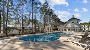 A swimming pool with lounge chairs, a gazebo, and a large building with a dome roof. - World Tour 104-206a (Myrtle Beach)