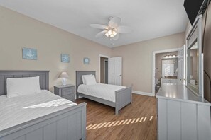 A bedroom with two beds, a ceiling fan, and a vanity with a mirror. - World Tour 306b (Myrtle Beach)
